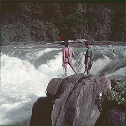 Loinclothed hobby; Obr�zek dne - the picture od the day - �awa rel -  Colour positive film of Wai Wai person and expedition team member overlooking massive waterfalls