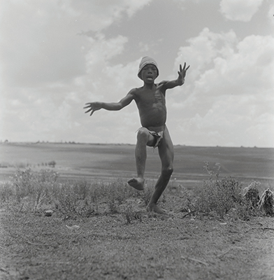 Creator:  Larrabee; Constance Stuart; 1914-2000; Produced:  1941 Phys. Descri  negative : b&w ; 6 x 6 cm. (silver gelatin). photographic print : b&w ; 8 x 10 in. (dupe print).; Subject Geog  South Africa Lesotho   Subjects:  Sotho (Basuto)  Form/Genre  Photographic prints; EEPA 1998-062657; [Summary:  Sotho Herd Boy; 1941. Photographic image of a boy jumping in mid-air. He is wearing a hat and loincloth. Photograph by Constance Stuart Larrabee; 1941. Constance Stuart took photographs in Basutoland (now Lesotho) during her first trip in 1941. In 1947; she returned to Lesotho as an officially accredited photographer. She documented a visit of the British royal family: King George VI; Queen Elizabeth and their daughters Princess Elizabeth and Margaret; to this British Protectorate. She used the occasion to venture into the countryside and captured unique images of rural life among the Sotho people. 
 