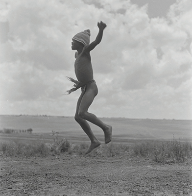 Creator:  Larrabee; Constance Stuart; 1914-2000; Produced:  1941 Phys. Descri  negative : b&w ; 6 x 6 cm. (silver gelatin). photographic print : b&w ; 8 x 10 in. (dupe print).; Subject Geog  South Africa Lesotho   Subjects:  Sotho (Basuto)  Form/Genre  Photographic prints; EEPA 1998-062657; [Summary:  Sotho Herd Boy; 1941. Photographic image of a boy jumping in mid-air. He is wearing a hat and loincloth. Photograph by Constance Stuart Larrabee; 1941. Constance Stuart took photographs in Basutoland (now Lesotho) during her first trip in 1941. In 1947; she returned to Lesotho as an officially accredited photographer. She documented a visit of the British royal family: King George VI; Queen Elizabeth and their daughters Princess Elizabeth and Margaret; to this British Protectorate. She used the occasion to venture into the countryside and captured unique images of rural life among the Sotho people. 
 